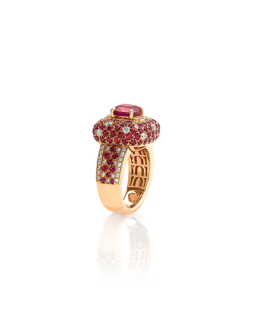 Ring in 18kt rose gold set with white diamonds (0.76 cts), rubies (3.34 cts), and one cushion cut ruby center stone (3.02 cts)