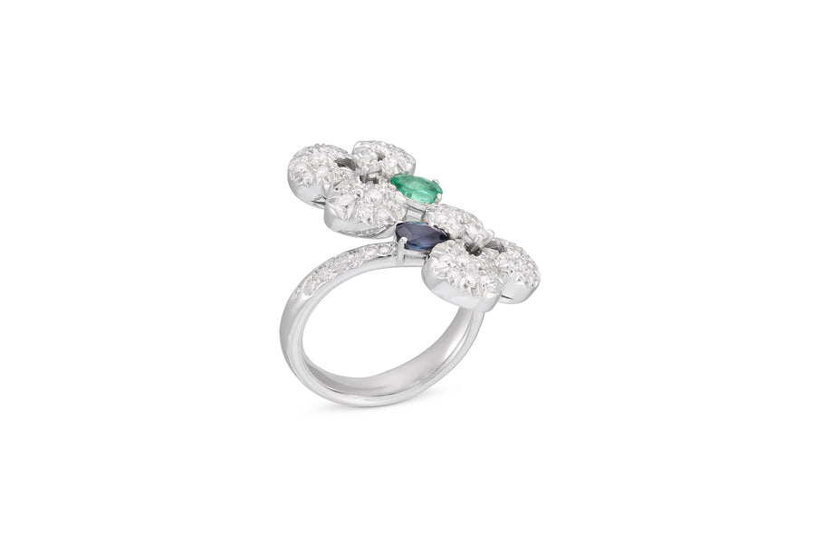 Ischia contraire ring in 18kt white gold set with white diamonds, one blue sapphire, and one emerald